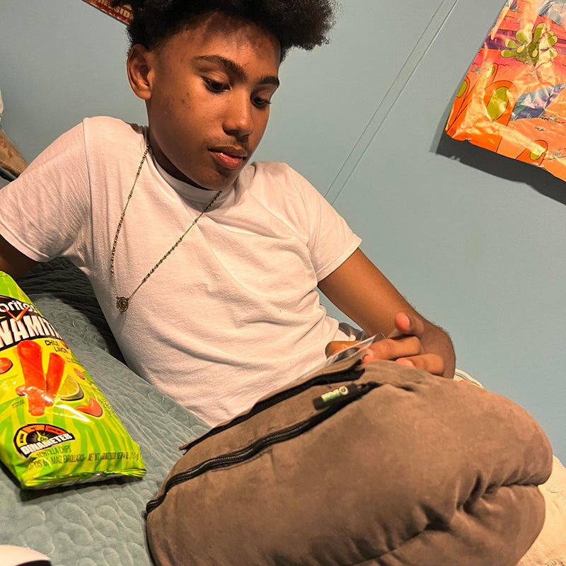 Teen child kid with smartphone cell phone potato pillow phone holder phone stand phone accessory gaming watching videos scrolling phone comfortable phone use 