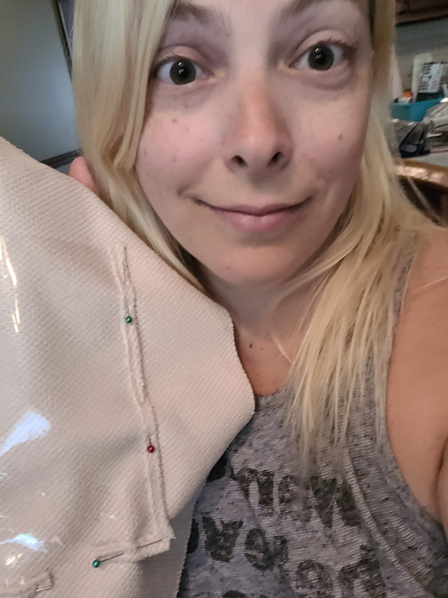 kim holding up a phonespud prototype with needles holding the vinyl screen pouch in place