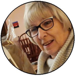 Woman with glasses and a beige sweater in a casual setting