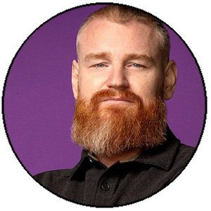 Man with a beard wearing a black shirt against a purple background